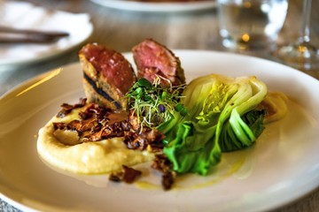 Pork tenderloin, mashed potato, pak choi and onion.