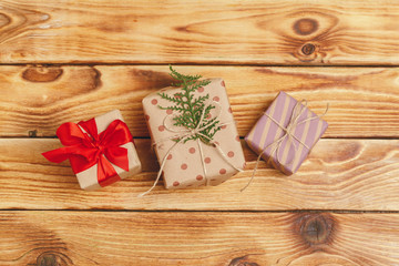 Small christmas gifts on wooden background, view from above