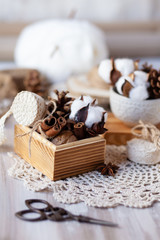 Family time to wrap christmas presents! Ideas for hand made gifts decor in rustic style, natural ingredients, cozy mood. Wooden background, scissors, lace, cones, cinnamon and cotton. Zero waste 