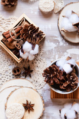 Time to wrap christmas presents! Ideas for hand made gifts decor rustic style, natural ingredients, cozy mood. Wooden background, scissors, rope, lace, cones, cinnamon and cotton. Flat lay top view