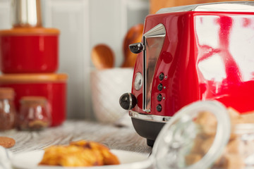 Kitchen shelf with red utensils and dishware