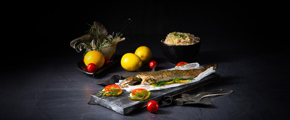 baked trout with herb filling and tomatoes