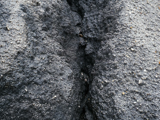Coal deposits in the quarry. Crack with black coal