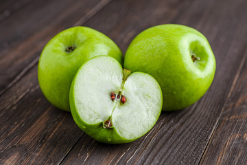 Ripe green apples and apple slices on old wooden background.Vegan and vegetarian concept.Concept for healthy eating and nutrition