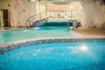 Obraz na płótnie Canvas the interior of the aquazone in a spa salon, swimming pools and a water fall