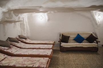 salt room in spa salon: relaxing beds in white interior