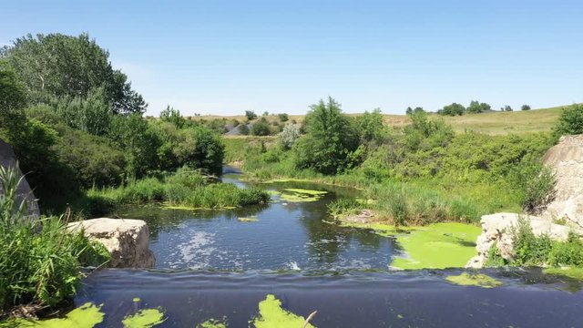 Wildlife of Russia: view of a winding river with a small waterfall