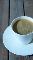 side view on cup of coffee on wooden table