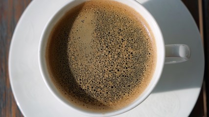 cup of coffee on wooden table