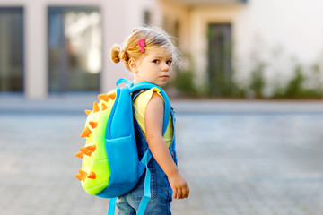 Cute little adorable toddler girl on her first day going to playschool. Healthy upset sad baby...