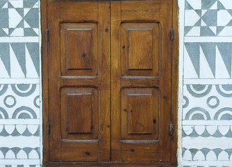 Wooden  on building exterior wall, Pyrgi village, Chios island, Greece.