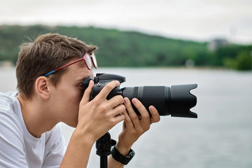 Man taking photos with a telephoto lens