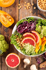 bowl of vegetable salad with cabbage, pumpkin, chickpea and grapefruit
