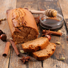 gingerbread cake with spices on wood background