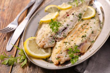 fish fillet cooked with oil, butter, herbs and lemon