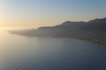 Scenic sunset over the mountainous coast of the Mediterranean sea.