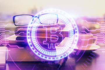 Obraz premium Crypto theme hologram with glasses on the table background. Concept of blockchain. Double exposure.