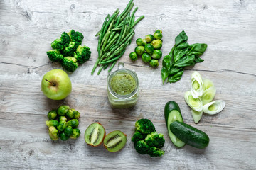 Fresh green food on a light table. Avocados cucumbers cabbage apples beans kiwi onions broccoli. The concept of healthy food, detox vegetarianism. Copy space flat lay.