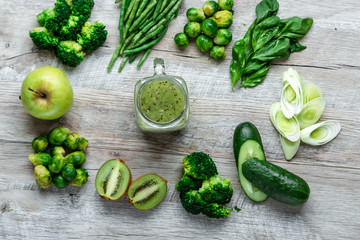 Fresh green food on a light table. Avocados cucumbers cabbage apples beans kiwi onions broccoli. The concept of healthy food, detox vegetarianism. Copy space flat lay.