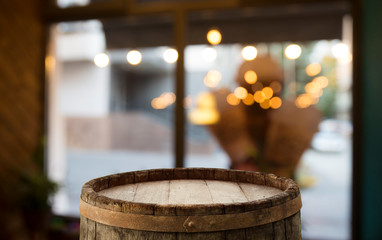 Empty wood table top on blur light gold bokeh of cafe restaurant in dark background