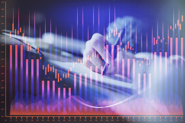 Financial forex graph displayed on hands taking notes background. Concept of research. Multi exposure