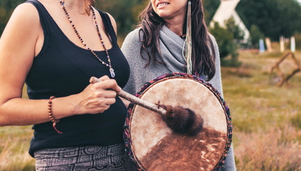 Shamanic drum in shaman womans hands. Ritual. Closeup