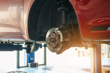 Close up disc brake at car service workshop