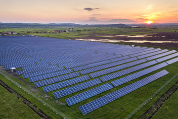 Blue solar photo voltaic panels system producing renewable clean energy on rural landscape and...