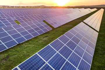Blue solar photo voltaic panels system producing renewable clean energy on rural landscape and...