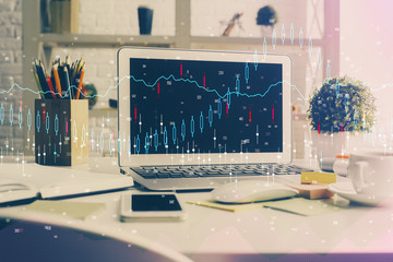 Financial graph colorful drawing and table with computer on background. Multi exposure. Concept of international markets.