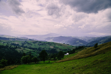 Fototapeta na wymiar Romantik landscape in the mountain village in the Hutsul region Dovhopillya