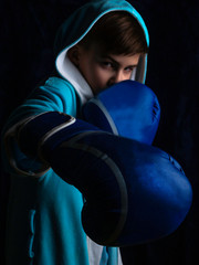 Aggressive child boy wearing boxing gloves, Low-key lighting