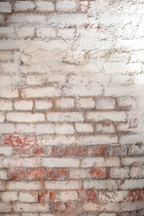 Textured brick wall with dilapidated stucco. Red brick and gray putty. View from above. Copy space.
