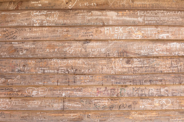 Messages scratched in a wooden wall