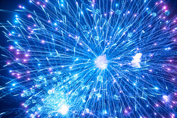 Blue firework in the night sky. Blue background