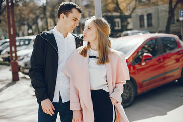 beautiful and stylish blonde along with her handsome guy walking around the sunny summer city