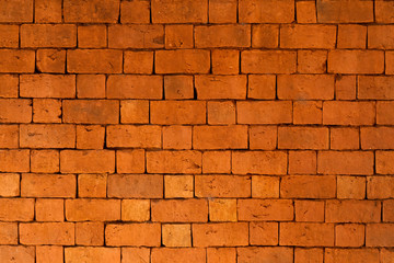 Obraz premium Brick wall, bright red stones from the red sand of Madagascar