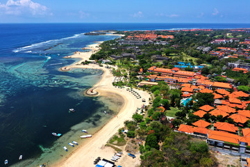 View of beautiful white sand beach and resorts, seen from Tanjung Benoa, Bali, on Holiday season.