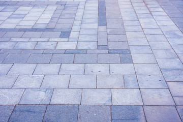 Grey brick pavement in the city in diagonal