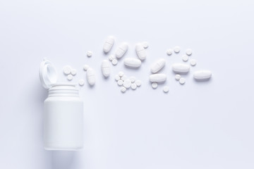 Spilled Pill Bottle isolated.Top view,.pharmacology concept. white pills