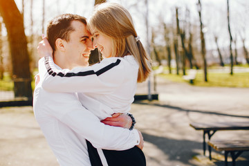 beautiful and stylish blonde along with her handsome guy walking around the sunny summer city