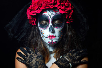 Portrait of woman dressed as catrina, skull to honor the dead in Mexico.