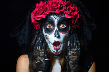 Portrait of woman dressed as catrina, skull to honor the dead in Mexico.