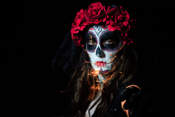 Portrait of woman dressed as catrina, skull to honor the dead in Mexico.
