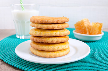 Obraz na płótnie Canvas Shortbread dairy cookies with milk and honey. A stack of cookies on a plate.