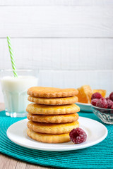 Shortbread dairy cookies with milk and honey. A stack of cookies on a plate.