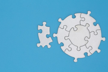 Unfinished white jigsaw puzzle pieces on blue background, The last jigsaw puzzle of success. - obrazy, fototapety, plakaty