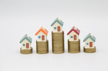 Mini house on stack of coins on white background., Concept of Investment property, Investment risk...