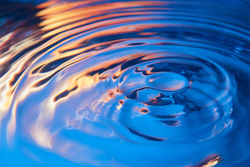 Abstract water waves background. Sunrise or sunset. Blue-red-yellow creative colors. Beautiful colorful art wallpaper