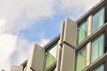 urban facade buildings with windows in perspective against the sky, fragment